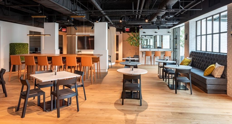 A cozy area with wooden tables and chairs arranged neatly in the center of the room.